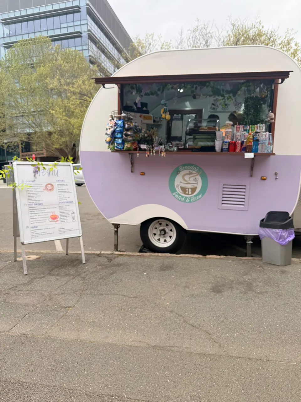 A pink coffee van parked outside on market day.